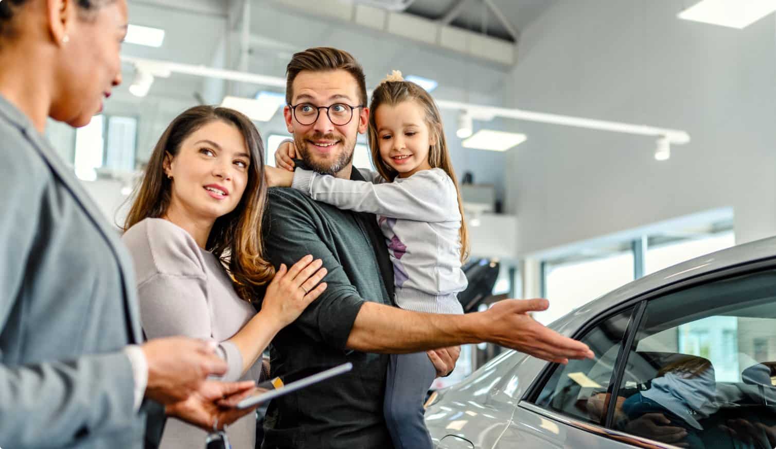 Family buying a new car in a dealership.