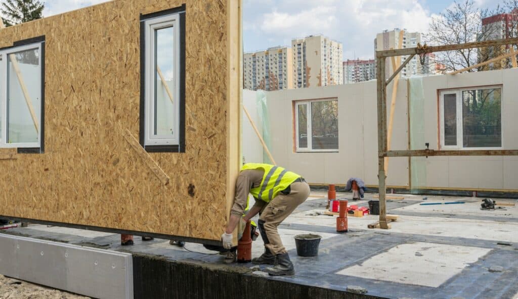A worker is working on the construction of a prefabricated house.